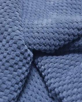 Macro view of a waffle-structured knit fabric
